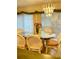 Bright dining room with an elegant chandelier and beautiful flower centerpiece at 1655 S Highland Ave # J194, Clearwater, FL 33756