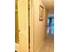 Hallway featuring a shower, tiled floors, and access to other areas of the home at 1655 S Highland Ave # J194, Clearwater, FL 33756