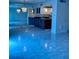 Living room with a large mirrored wall and tile floors at 1655 S Highland Ave # J194, Clearwater, FL 33756