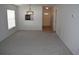 Living room features grey carpet, a chandelier, and views of the entryway at 2250 Druid E Rd # 605, Clearwater, FL 33764