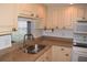 Bright kitchen with light cabinets, granite counters, and stainless steel sink at 2250 Druid E Rd # 605, Clearwater, FL 33764
