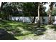 Large backyard with lush lawn and mature trees, offering privacy at 2250 Druid E Rd # 605, Clearwater, FL 33764