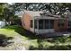 Screened-in porch and patio area adjacent to a grassy yard at 2250 Druid E Rd # 605, Clearwater, FL 33764