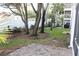 Landscaped backyard with brick patio and trees at 9720 Indian Key Trl # 117, Seminole, FL 33776