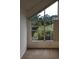 Bedroom with a large window and treetop views at 9720 Indian Key Trl # 117, Seminole, FL 33776