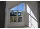 Bright bedroom with large window offering treetop views at 9720 Indian Key Trl # 117, Seminole, FL 33776