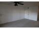 Carpeted bedroom with an interior door and ceiling fan at 9720 Indian Key Trl # 117, Seminole, FL 33776