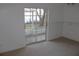 Carpeted bedroom with sliding glass doors leading to a patio at 9720 Indian Key Trl # 117, Seminole, FL 33776