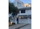 Two-story white townhouse with a two-car garage and landscaping at 9720 Indian Key Trl # 117, Seminole, FL 33776