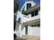 White two story home with green door and attached garage at 9720 Indian Key Trl # 117, Seminole, FL 33776