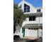 Two-story white townhouse with a two-car garage and landscaping at 9720 Indian Key Trl # 117, Seminole, FL 33776