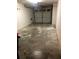 Unfinished garage with stained concrete floor and overhead door at 9720 Indian Key Trl # 117, Seminole, FL 33776