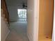 Hallway view of carpeted stairs, living room, and tiled bathroom at 9720 Indian Key Trl # 117, Seminole, FL 33776