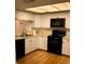 Kitchen features white cabinets and black appliances at 9720 Indian Key Trl # 117, Seminole, FL 33776