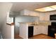 Modern kitchen with white cabinets and a breakfast bar at 9720 Indian Key Trl # 117, Seminole, FL 33776