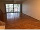 Spacious living room with wood floors and sliding glass doors to balcony at 9720 Indian Key Trl # 117, Seminole, FL 33776