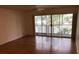 Living room with hardwood floors and sliding glass doors to balcony at 9720 Indian Key Trl # 117, Seminole, FL 33776