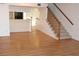Hardwood floor living room with kitchen and stairs visible at 9720 Indian Key Trl # 117, Seminole, FL 33776