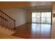Spacious living room with hardwood floors and balcony access at 9720 Indian Key Trl # 117, Seminole, FL 33776