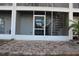 Brick patio with screened porch and spiral stairs at 9720 Indian Key Trl # 117, Seminole, FL 33776