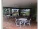 Community patio with shaded seating area and multiple tables at 9720 Indian Key Trl # 117, Seminole, FL 33776