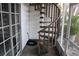 Exterior spiral staircase next to a sliding glass door at 9720 Indian Key Trl # 117, Seminole, FL 33776