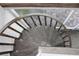 View of a rustic spiral staircase leading to an upper level at 9720 Indian Key Trl # 117, Seminole, FL 33776