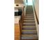 Interior view of a carpeted staircase with wooden railings at 9720 Indian Key Trl # 117, Seminole, FL 33776