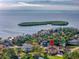 Gorgeous aerial view of waterfront home with ocean views and lush landscaping at 2066 N Pointe Alexis Dr, Tarpon Springs, FL 34689