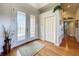 Foyer with decorative glass doors, hardwood flooring, and a view into adjacent living space at 2066 N Pointe Alexis Dr, Tarpon Springs, FL 34689