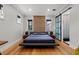Spacious bedroom with a platform bed and sliding barn door to en-suite bathroom at 851 Brightwaters Ne Blvd, St Petersburg, FL 33704