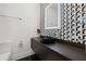 Modern bathroom with a sleek vanity and geometric tile at 851 Brightwaters Ne Blvd, St Petersburg, FL 33704