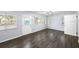 Living room with vinyl flooring, multiple windows and access to the backyard at 1320 Woodbine St, Clearwater, FL 33755