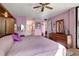 Cozy bedroom featuring a large bed, wood floors, and access to an ensuite bathroom and closet at 14130 Rosemary Ln # 3309, Largo, FL 33774