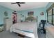 Cozy bedroom with a ceiling fan, double bed, and decoratively painted blue walls at 14130 Rosemary Ln # 3309, Largo, FL 33774