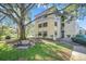 Multi-story residential building with lush landscaping and mature trees creating a park-like setting at 14130 Rosemary Ln # 3309, Largo, FL 33774