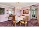Inviting dining room featuring a chandelier, a mirror, and seamless connection to the living area at 14130 Rosemary Ln # 3309, Largo, FL 33774