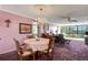 Dining room with chandelier and views of the outside, seamlessly connected to the living area at 14130 Rosemary Ln # 3309, Largo, FL 33774