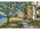 Beautiful view of the exterior of the building, with mature landscaping and a lake in the background at 14130 Rosemary Ln # 3309, Largo, FL 33774
