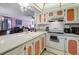 Kitchen features white appliances and coral cabinets at 14130 Rosemary Ln # 3309, Largo, FL 33774