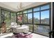 Bright sunroom features a table for dining and scenic lake views at 14130 Rosemary Ln # 3309, Largo, FL 33774