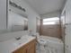 Clean bathroom featuring a bathtub, toilet and wood vanity at 16003 2Nd E St, Redington Beach, FL 33708