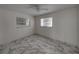 Bright bedroom with marble floors and two windows at 16003 2Nd E St, Redington Beach, FL 33708