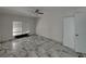 Bright bedroom with marble-look floors and a ceiling fan at 16003 2Nd E St, Redington Beach, FL 33708