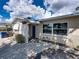 Front view of a tan house with blue door and decorative screen at 16003 2Nd E St, Redington Beach, FL 33708