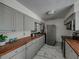 Modern kitchen with gray cabinets and wood countertops at 16003 2Nd E St, Redington Beach, FL 33708