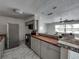 Kitchen with gray cabinets, wood countertops, and a breakfast bar at 16003 2Nd E St, Redington Beach, FL 33708