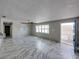 Spacious living room with marble-look floors and a ceiling fan at 16003 2Nd E St, Redington Beach, FL 33708