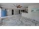 Open living area with marble flooring, and a view into the kitchen at 16003 2Nd E St, Redington Beach, FL 33708