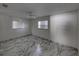 Empty bedroom with marble-look floors and two windows at 16003 2Nd E St, Redington Beach, FL 33708